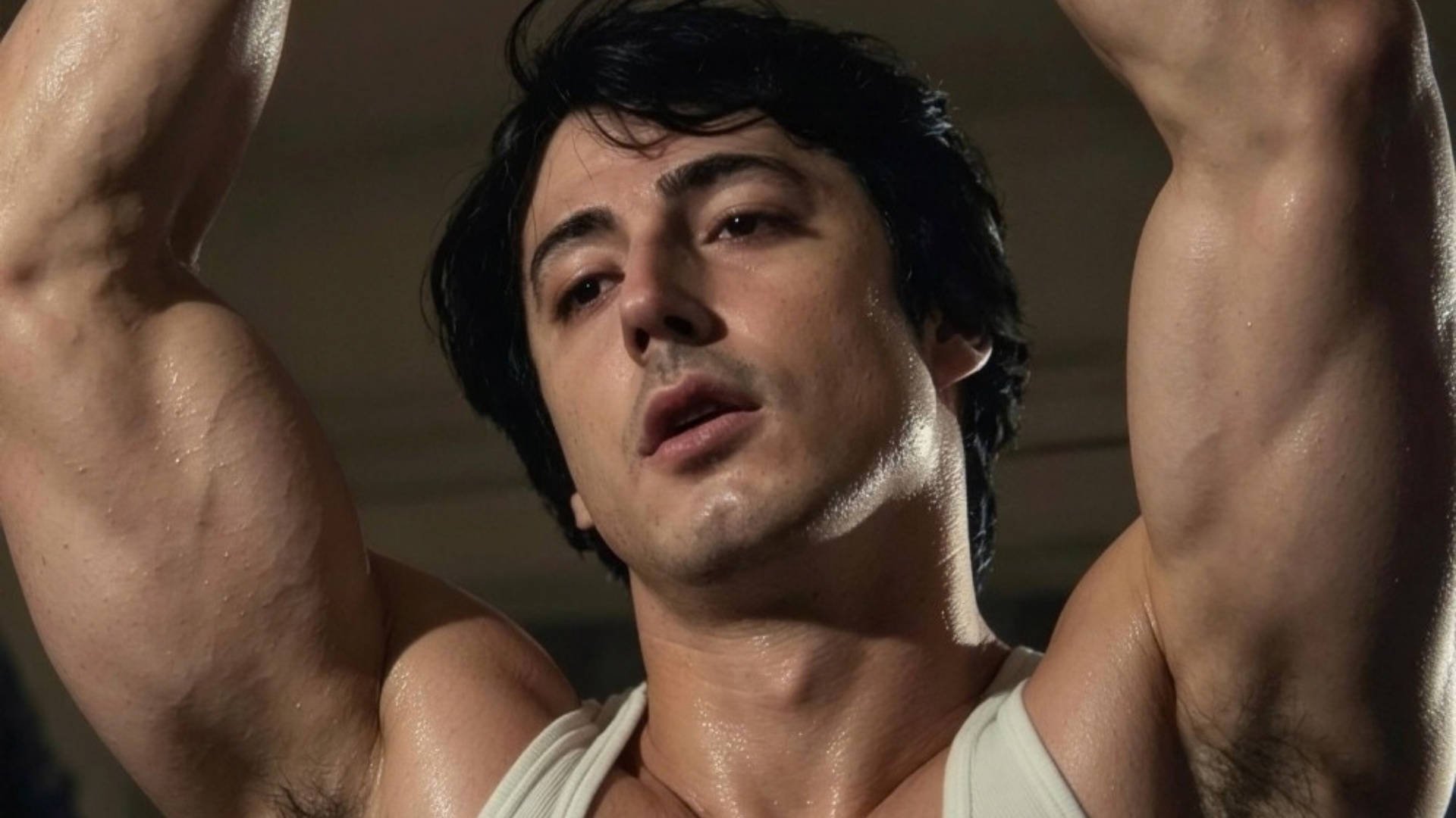 Muscular Man Shirtless with Arms Raised, Sweaty Skin and a Focused Expression, Looking Upward.