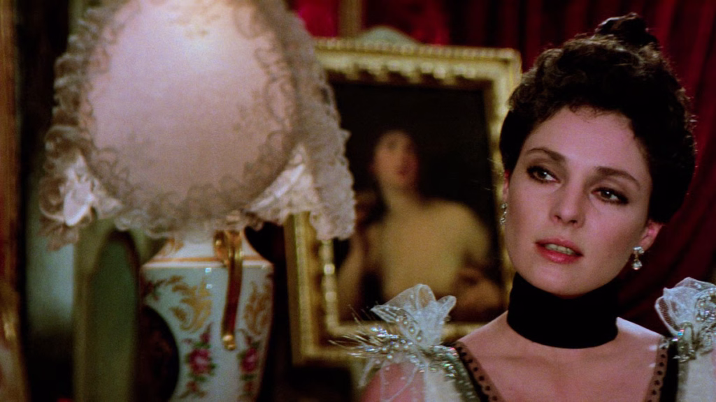 L_innocente_nyff64_04jpg | the Cinema Group Woman in an Antique Gown with a Black Velvet Choker, in a Luxurious Room with a Lace Lamp and a Gilded Framed Portrait Behind Her.