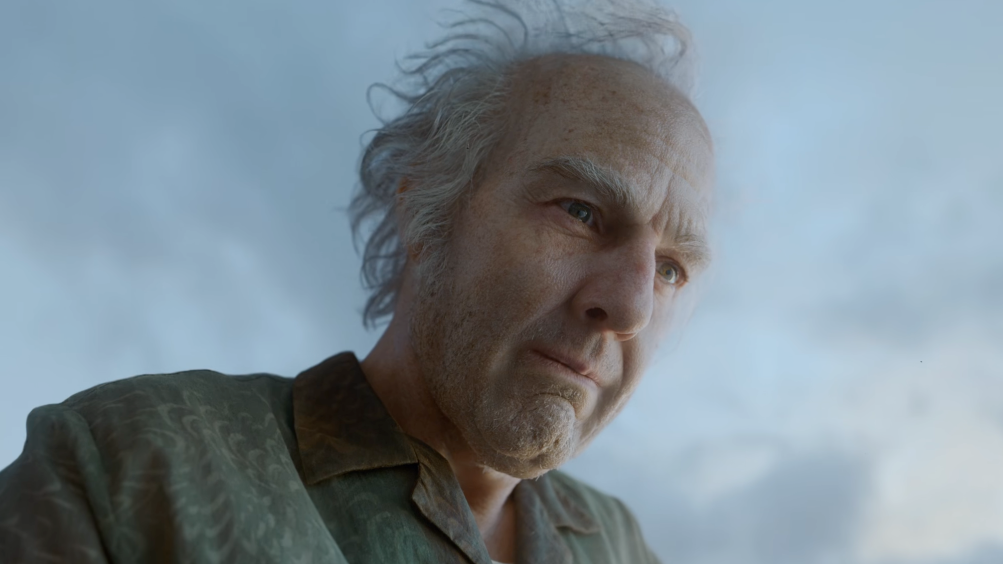 Close-up of an Elderly Man with Gray Hair Looking to the Side Against a Blue Sky Background.