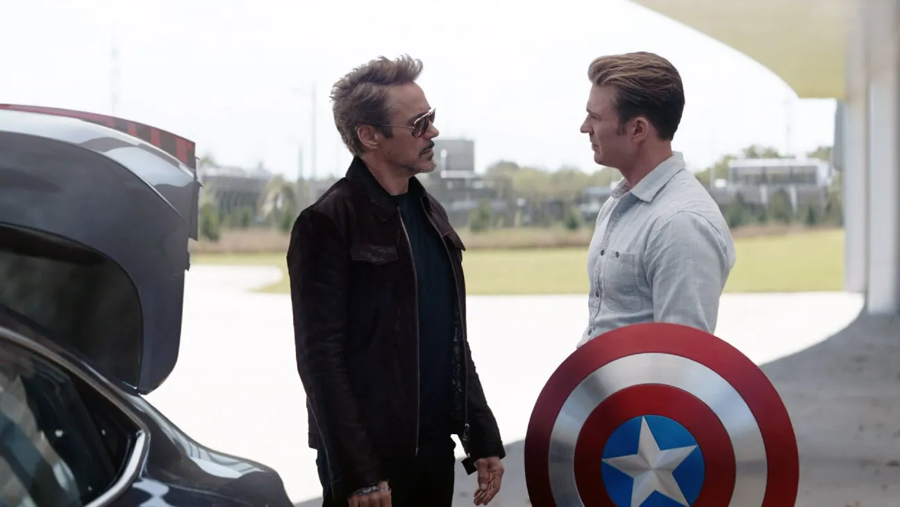 Mcdaven_ec262-2jpg | the Cinema Group Two Men Chat Beside a Car with Its Trunk Open; One Wears Sunglasses, the Other Holds a Captain America Shield.