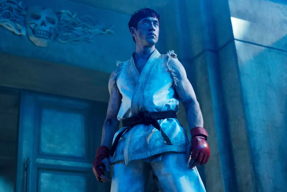 Mcdstfi_pa038jpg | the Cinema Group Male Martial Artist Wearing a White Gi with a Black Belt and Red Gloves Stands in a Blue-lit Scene, Looking Upward.