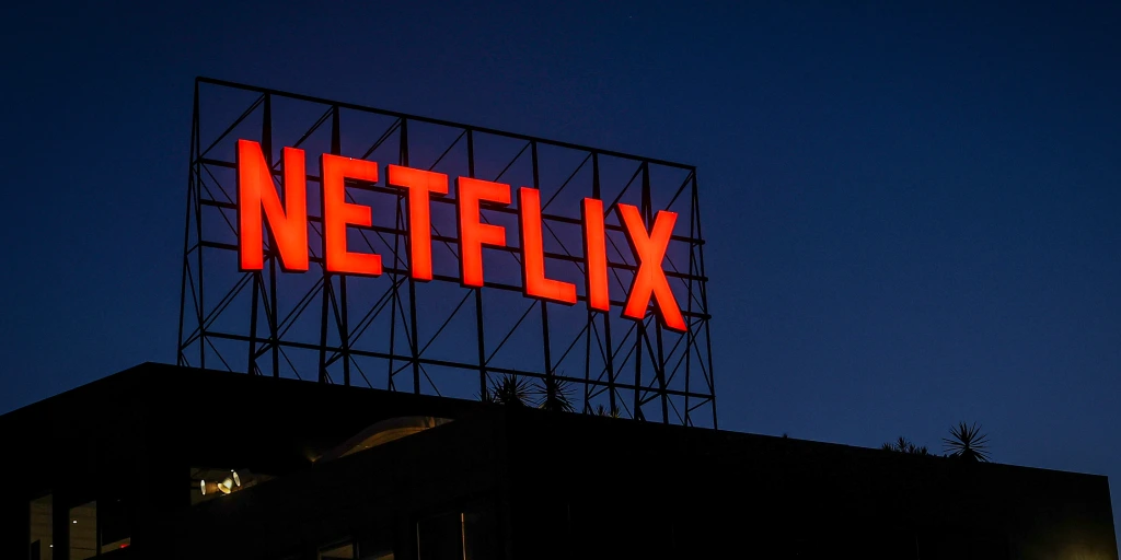 Netflix- the Cinema Group 7 | the Cinema Group Red Netflix Sign on a Rooftop Structure Against a Deep Blue Evening Sky
